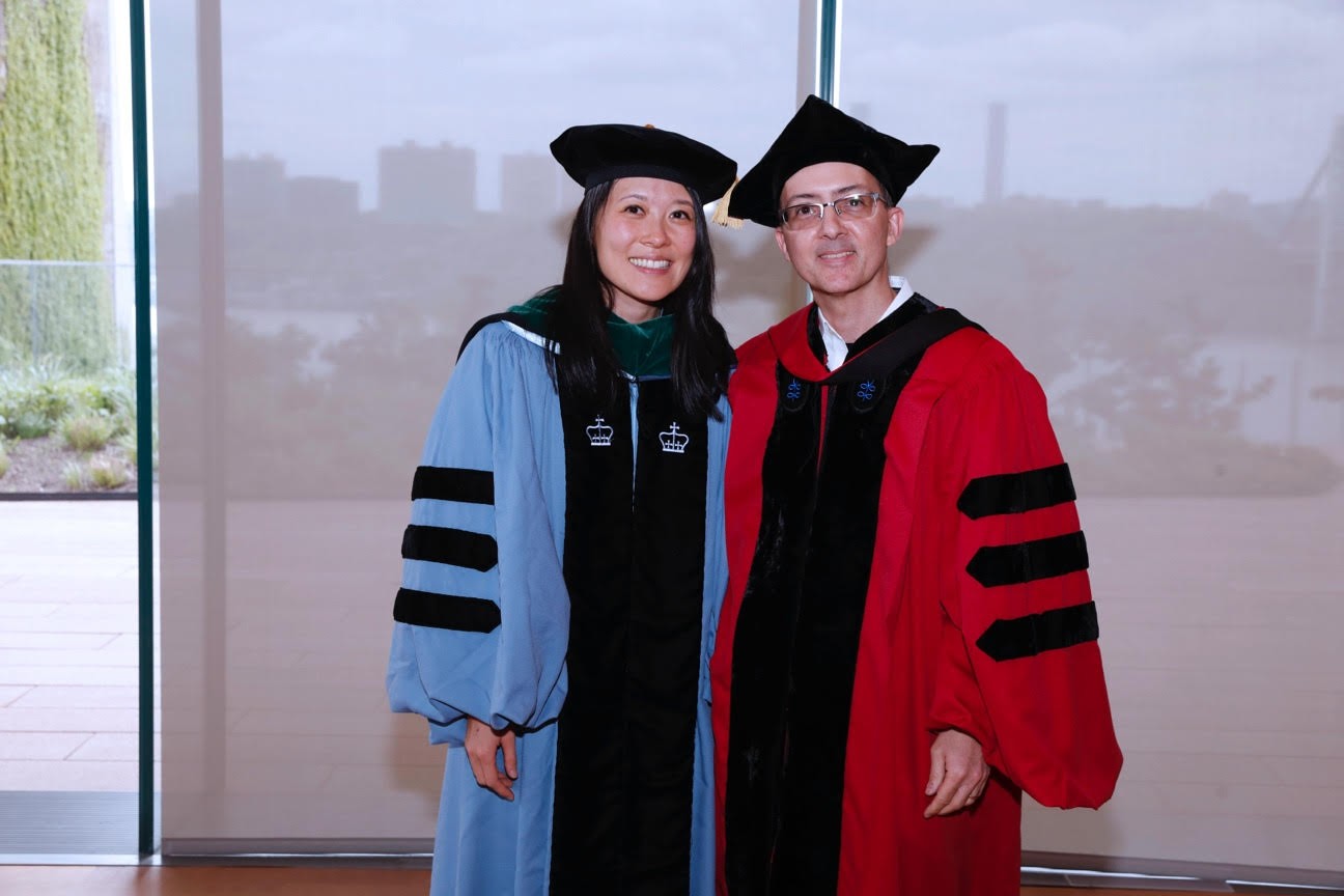 Dr. Annie Lin standing next to Dr. Brent Stockwell, both in full doctoral regalia.